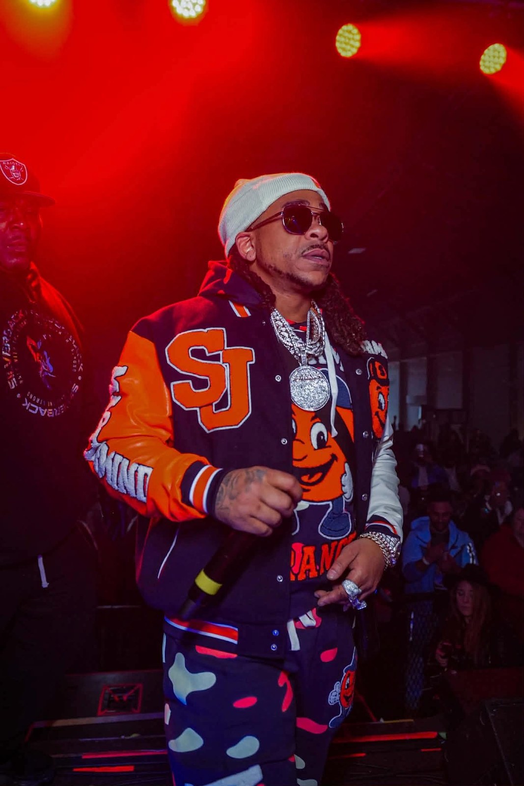 Max B performing in a varsity jacket